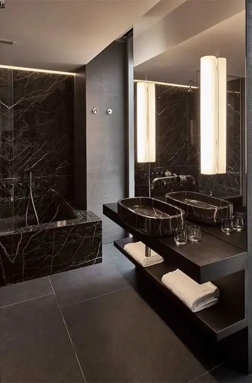Modernes Badezimmer mit stilvollen Waschbecken und dunklen Akzenten