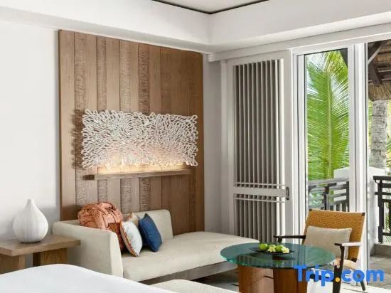 Sitzbereich im Hotelzimmer mit Kunst und Zugang zum Balkon