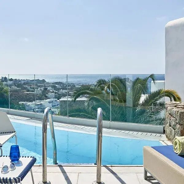 Pool mit Meerblick und Palmen am Myconian Ambassador Hotel