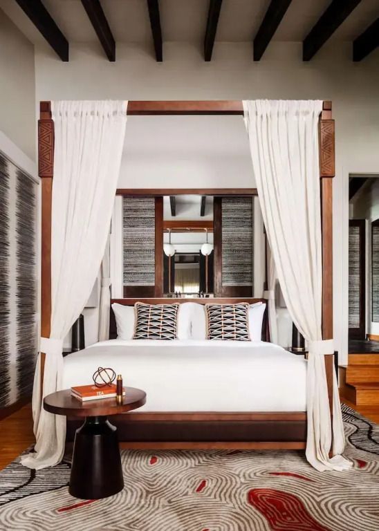 Luxuriöses Zimmer mit Himmelbett und Holzdekor