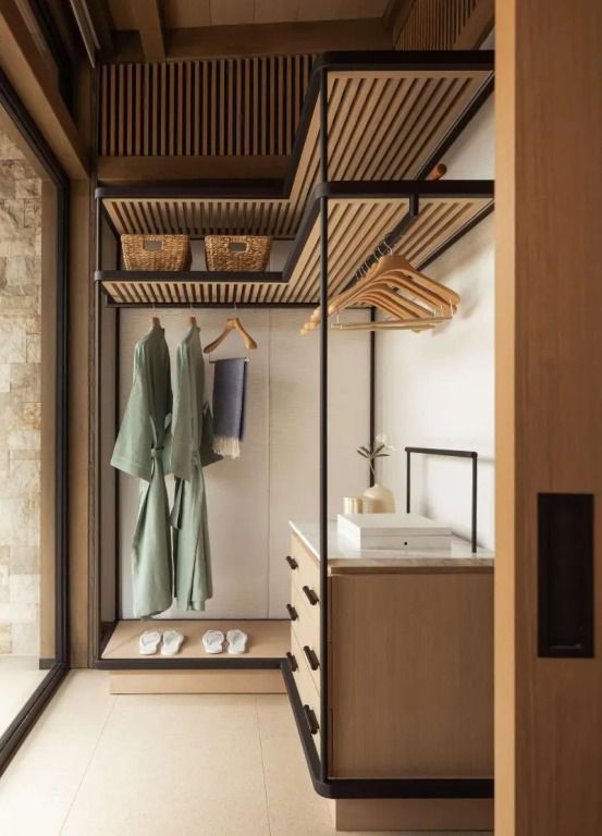Offener Kleiderschrank mit Holzdetails und bereitgestellten Bademänteln.