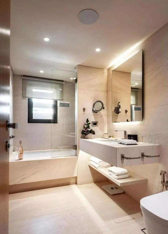 Modernes Badezimmer mit großer Spiegelwand und beleuchteten Waschtisch