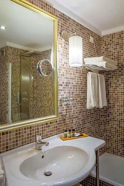 Elegantes Badezimmer mit Mosaikfliesen und modernen Annehmlichkeiten