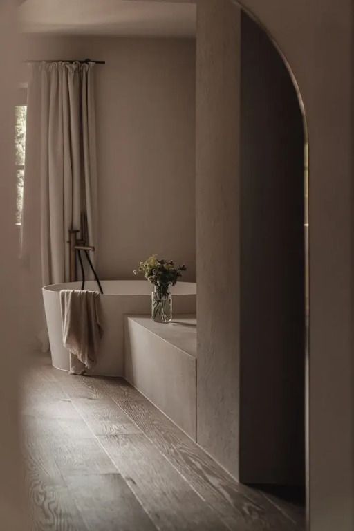 Minimalistisches Badezimmer mit Wanne und Natursteinoptik