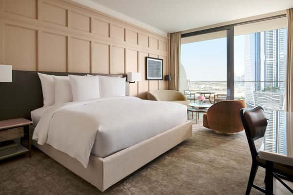 Komfortables Doppelbett im Sunrise Zimmer mit Blick auf die Stadt durch große Fenster