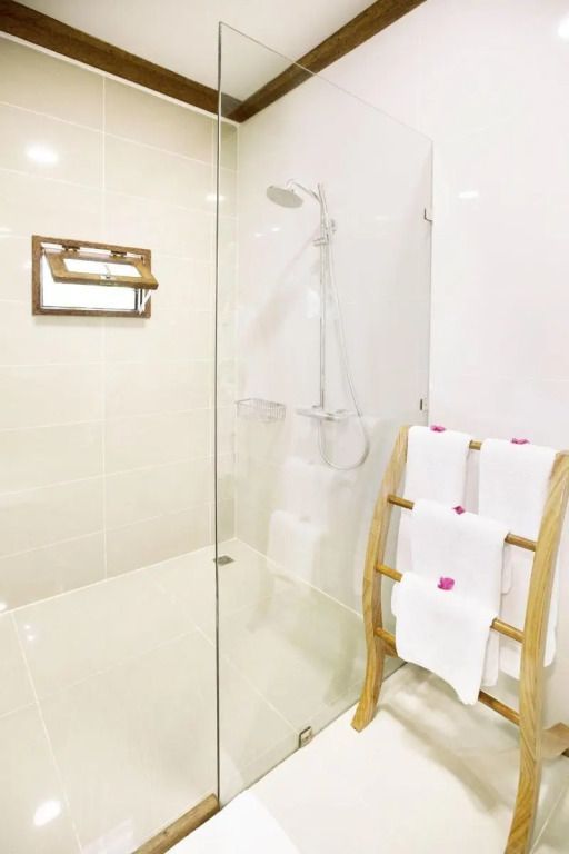 Moderne Dusche mit Glaswand im Deluxe Bungalow im Tulia Zanzibar Resort