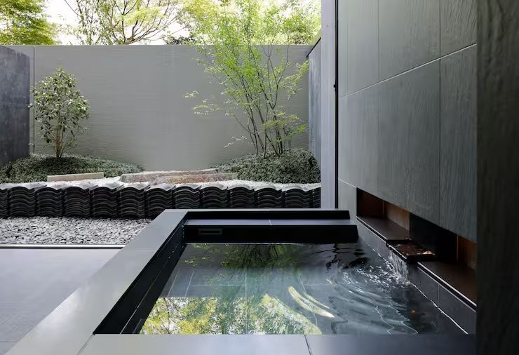 Private Onsen-Therme mit Blick auf eine grüne Gartenlandschaft