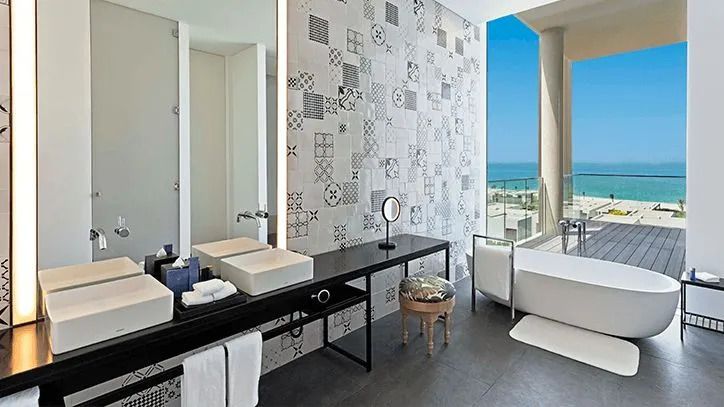 Luxuriöses Badezimmer mit großen Fenstern und Meerblick