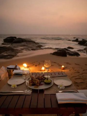 Romantisches Abendessen am Strand mit Kerzenlicht und Meerblick