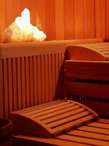 Sauna mit hölzernem Interieur und sanfter Beleuchtung