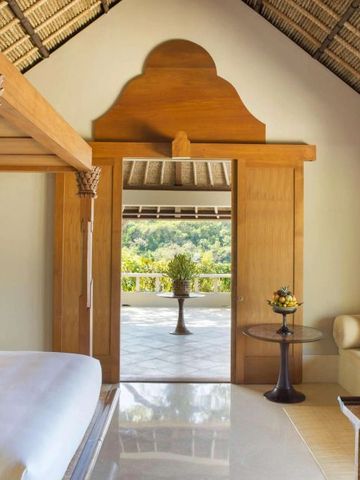 Elegantes Schlafzimmer mit Himmelbett und Blick auf Terrasse.