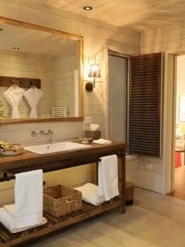 Großes Badezimmer mit Holzakzenten und eleganter Beleuchtung
