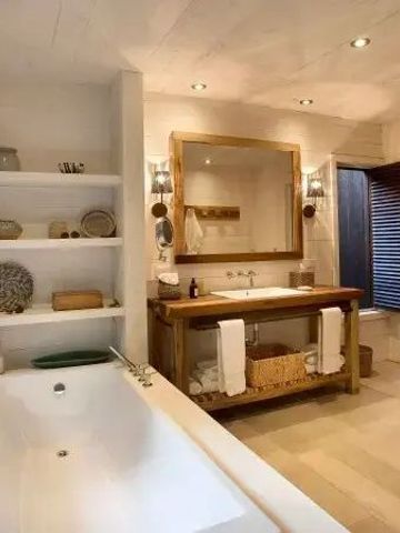 Modernes Badezimmer mit freistehender Badewanne und großen Spiegeln
