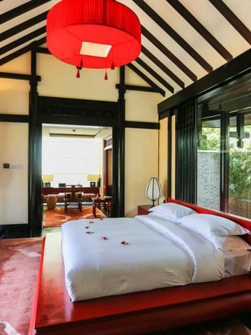 Elegantes Schlafzimmer mit moderner asiatischer Einrichtung und Blick auf die Terrasse