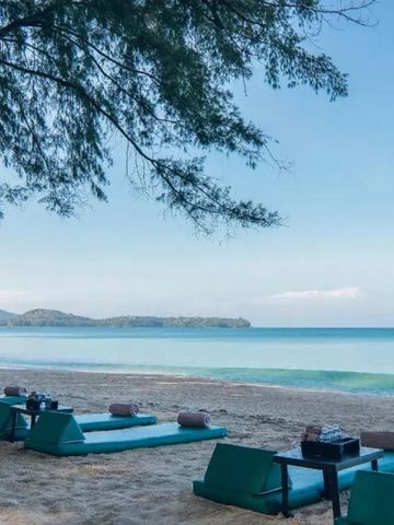 Sandstrand mit blauen Liegen und Blick auf das Meer im Banyan Tree Phuket.