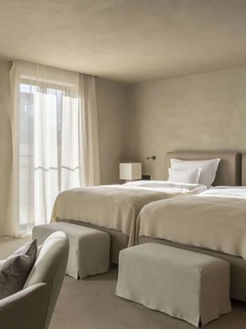 Elegantes Doppelzimmer mit modernen Möbeln und großen Fenstern