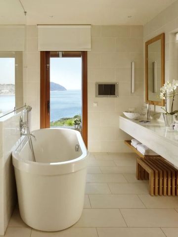 Luxuriöses Badezimmer mit freistehender Badewanne und Meerblick