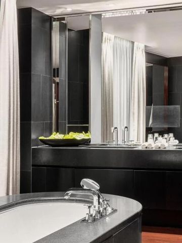 Elegantes Badezimmer mit dunklem Marmordesign und Spiegeln