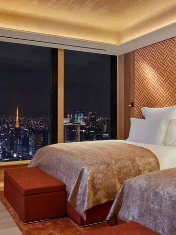 Zimmer mit zwei Betten und nächtlicher Stadtansicht im Bvlgari Hotel Tokyo