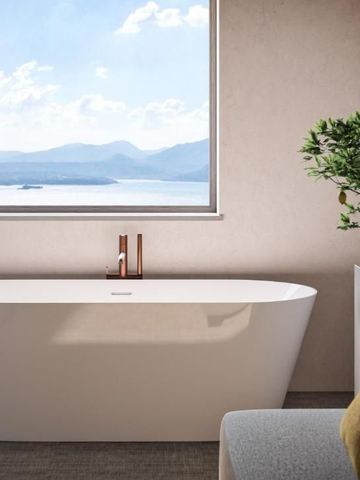 Freistehende Badewanne mit Seeblick und eleganter, minimalistischer Einrichtung