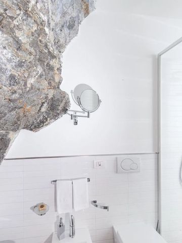 Modernes Badezimmer mit natürlichem Felsen im Casa Angelina Hotel
