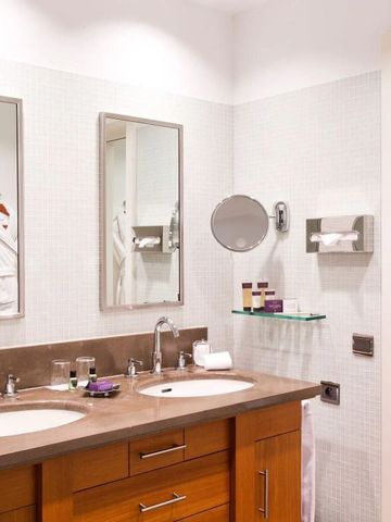 Badezimmer mit Doppelwaschbecken und weißen Handtüchern