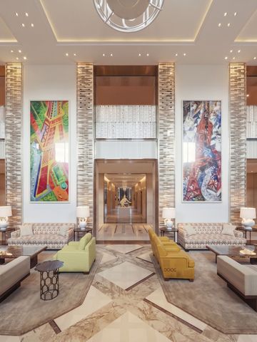Luxuriöse Hotel-Lobby mit stilvollen Sitzbereichen und Kunstwerken an den Wänden.