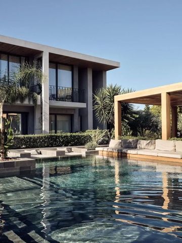 Luxuriöser Poolbereich mit modernen Suiten im Hintergrund und Palmen