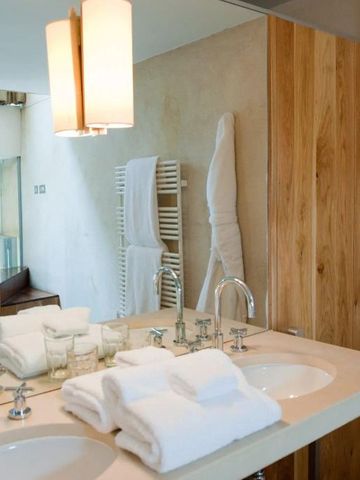 Luxuriöses Badezimmer mit Doppelwaschbecken und eleganten Holzdetails