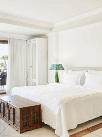 Helles Schlafzimmer mit Balkon und Blick auf die Natur, stilvoll eingerichtetes Hotelzimmer.