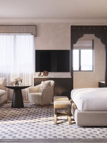 Luxuriöses Schlafzimmer mit Sitzecke und eleganten Dekorationen
