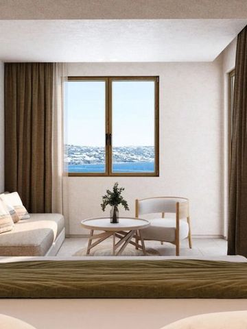 Helles Zimmer mit Meerblick durch großzügiges Fenster.