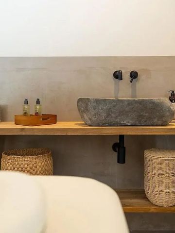 Waschtisch mit Steinwaschbecken und Naturdekorationen