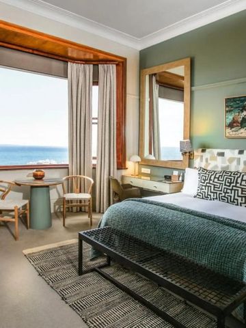 Geräumiges Schlafzimmer mit großem Fenster und Meerblick