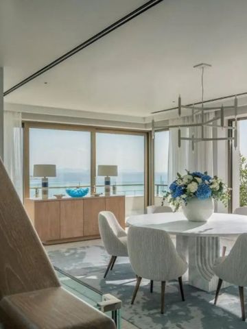 Luxuriöser Essbereich in einer Suite mit rundem Marmortisch und Blick aufs Meer.