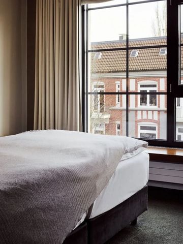 Gemütliches Hotelzimmer mit großem Fenster und Stadtblick