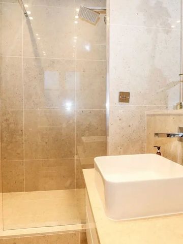 Modernes Badezimmer mit eleganter Dusche und stilvollem Waschbecken.