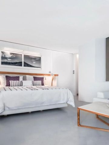 Helles Hotelzimmer mit großem Bett und minimalistischer Dekoration