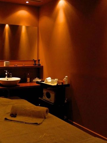 Spa-Behandlungsraum mit warmen Farben und gemütlicher Einrichtung.