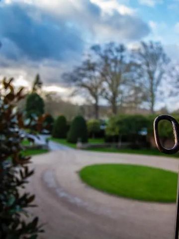 Gartenweg mit Blick auf den Himmel durch ein geschmiedetes Tor