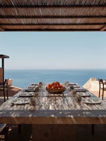 Essbereich mit Tisch und Stühlen unter Holzpergola vor atemberaubendem Meerblick