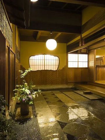 Traditioneller japanischer Eingangsbereich mit Laterne und Pflanzen