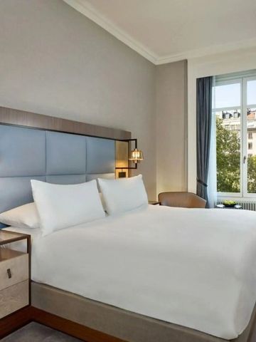 Bequemes Hotelzimmer mit großem Bett und Fensterblick im Hotel de la Paix