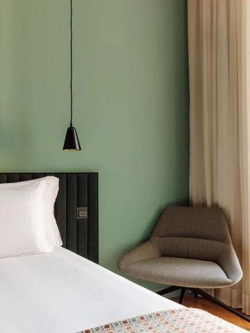 Modernes Zimmer mit grünem Akzent und eleganter Beleuchtung