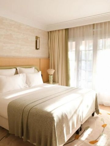 Lichtdurchflutetes Zimmer mit gemütlichem Doppelbett und eleganter Einrichtung.
