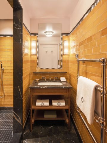 Luxuriöses Badezimmer mit gelben Fliesen und elegantem Waschtisch