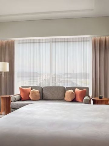 Geräumiges Zimmer mit Sofa und großen Fenstern, elegantes modernes Interieur