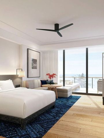 Helles Hotelzimmer mit Meerblick und moderner Einrichtung.
