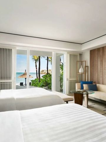 Geräumiges Doppelzimmer mit Blick auf Palmen und Meer im Shangri-La Le Touessrok.