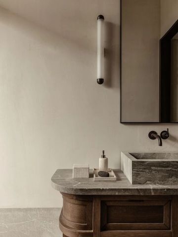 Elegantes Badezimmer mit Waschtisch aus Marmor und stilvollem Dekor